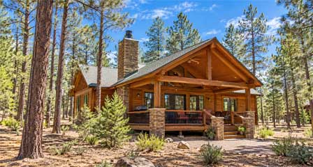 Rustic Arizona mountain vacation cabin surrounded by tall pine trees