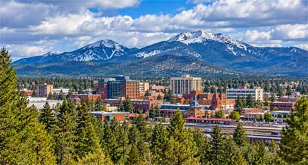Flagstaff Arizona cityscape with pine forests and the San Francisco Peaks in the distance