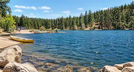 Boat launch and pine-covered shoreline at Goldwater Lake near Prescott Arizona