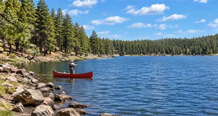 Angler trout fishing from a canoe on Hawley Lake Arizona