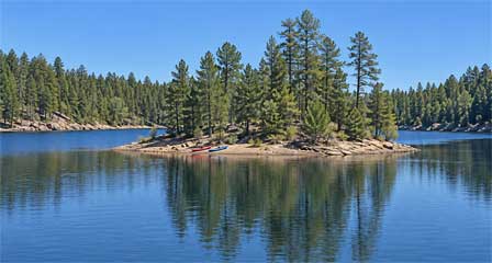 Meyer Island at Knoll Lake Arizona with kayaks along the forested shoreline