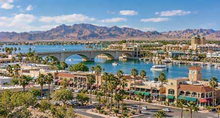 Downtown Lake Havasu City Arizona with buildings, streets and surrounding desert mountains