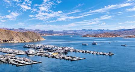 Lake Mead marina with boats, houseboats and desert mountains along the Arizona-Nevada shoreline