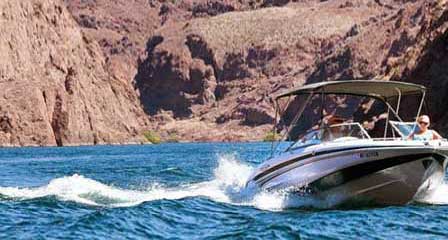 Recreational boating on Lake Mead surrounded by rugged desert mountains and canyons
