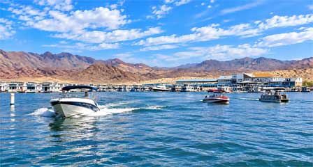 Boats leaving Lake Mead Marina to enjoy a day on the water surrounded by colorful mountain scenery
