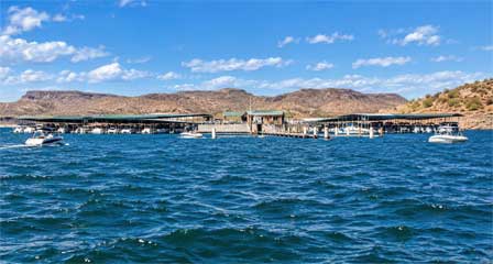 Scorpion Bay Marina on Lake Pleasant with covered boat docks, pleasure boats and desert mountains