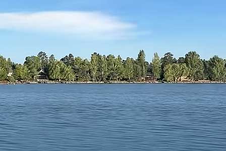 Rainbow Lake surrounded by pine forest and lakeside homes in Pinetop-Lakeside Arizona