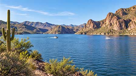 Pleasure boats on Saguaro Lake near Phoenix with desert canyon scenery