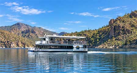 Desert Belle sightseeing boat on Saguaro Lake around canyon walls in Arizona
