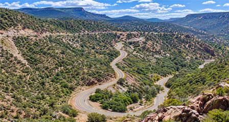 Winding switchbacks along the Coronado Trail Scenic Byway through rugged forested mountains in eastern Arizona