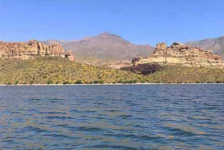 Apache Lake Arizona surrounded by rugged canyon mountains along the Apache Trail